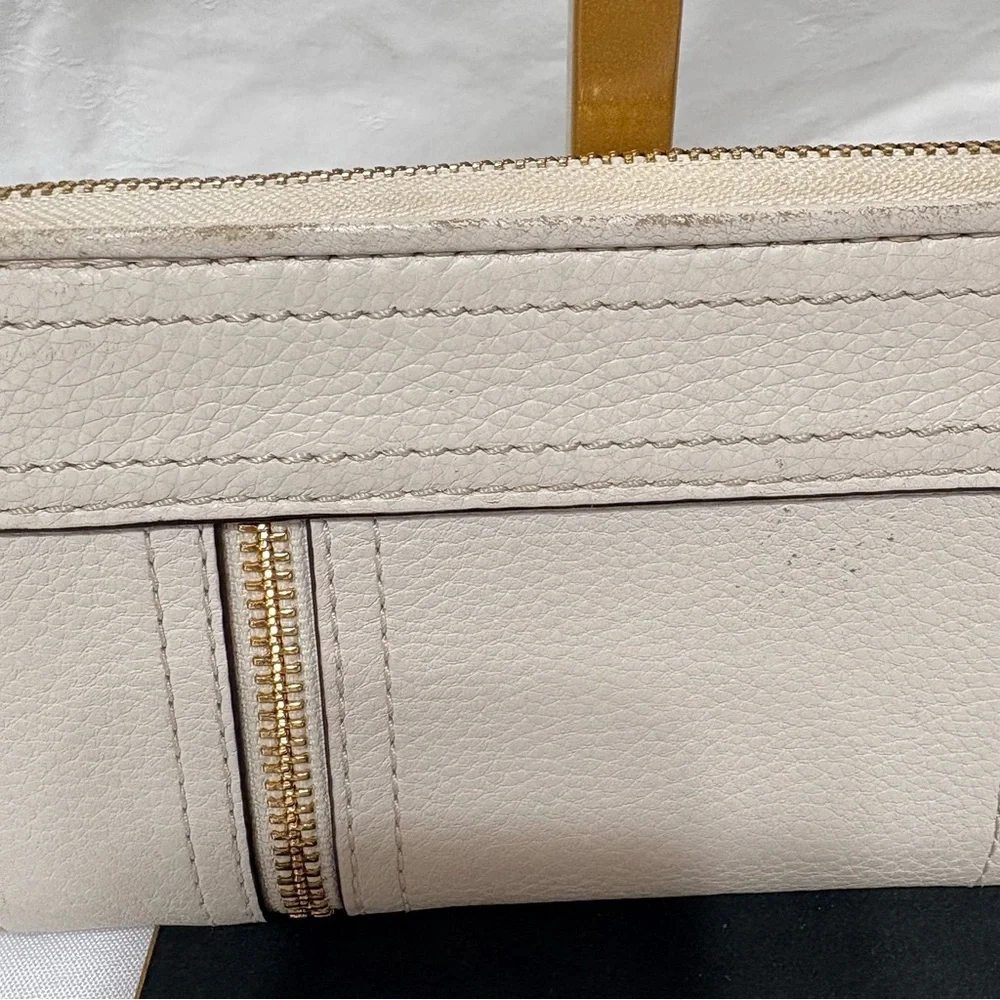 Michael Kors Moxley continental zip-around wallet in vanilla or cream leather.